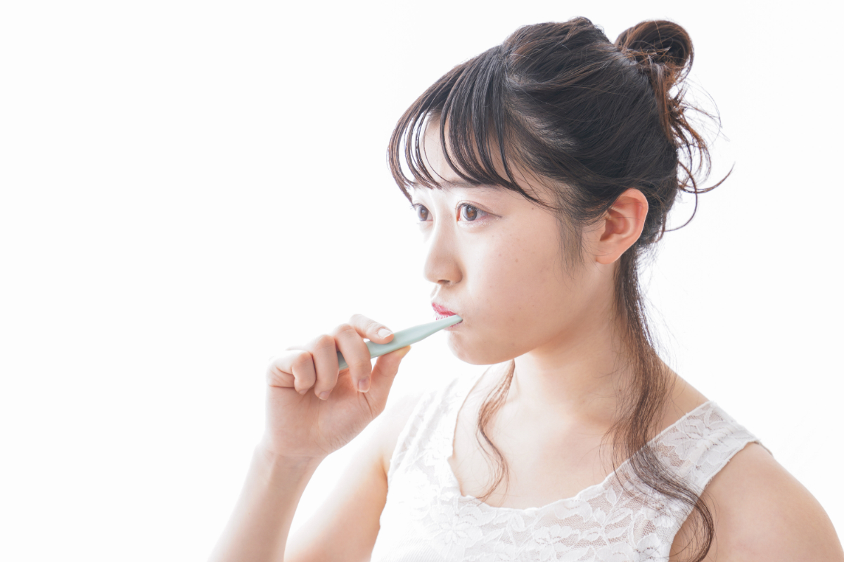ホワイトニングでしみるのを予防するために丁寧に歯磨きする女性
