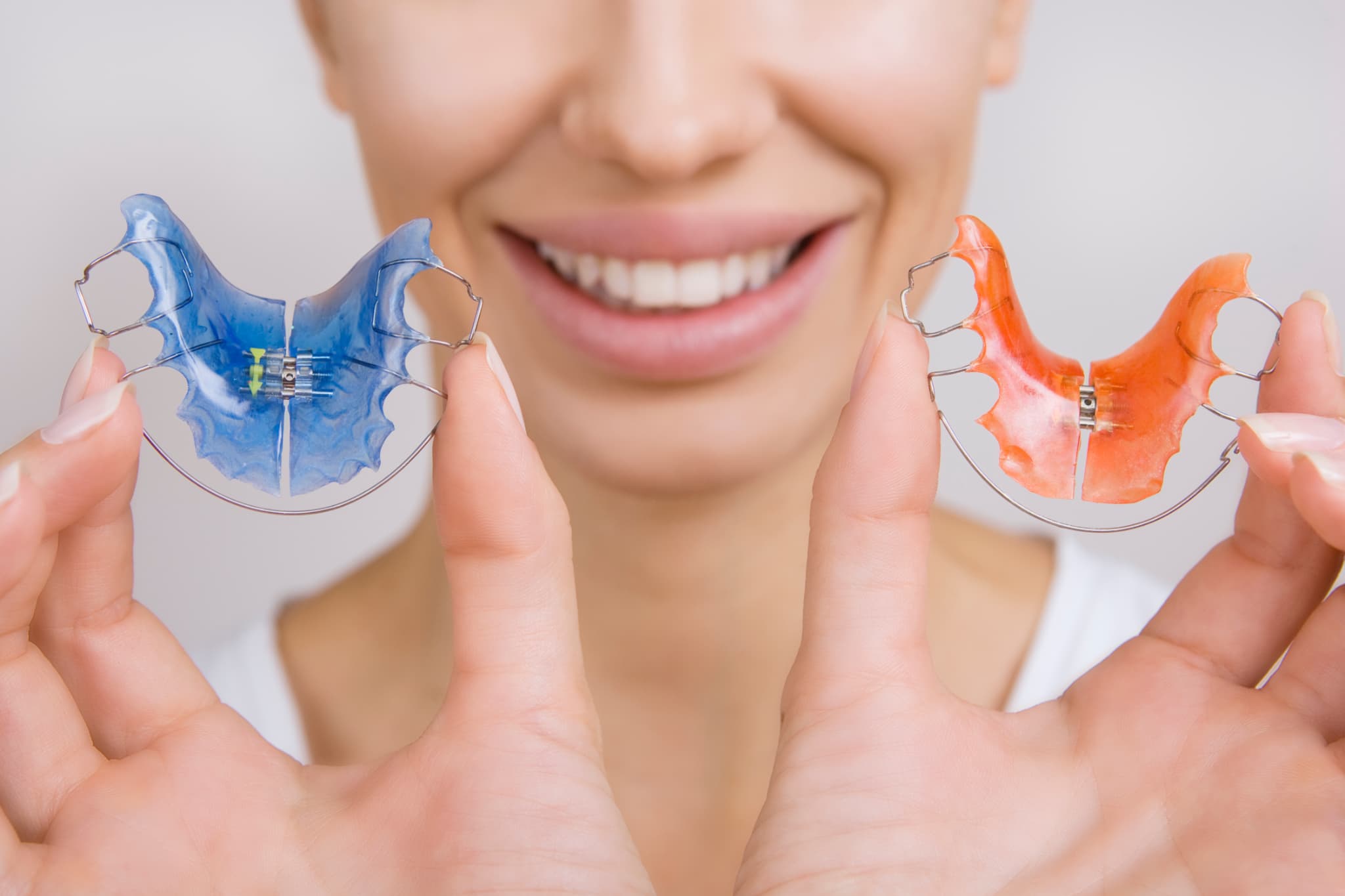 リテーナーを手に持った笑顔の人